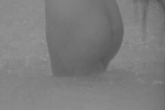 Юная киргизка купается в реке под дождем